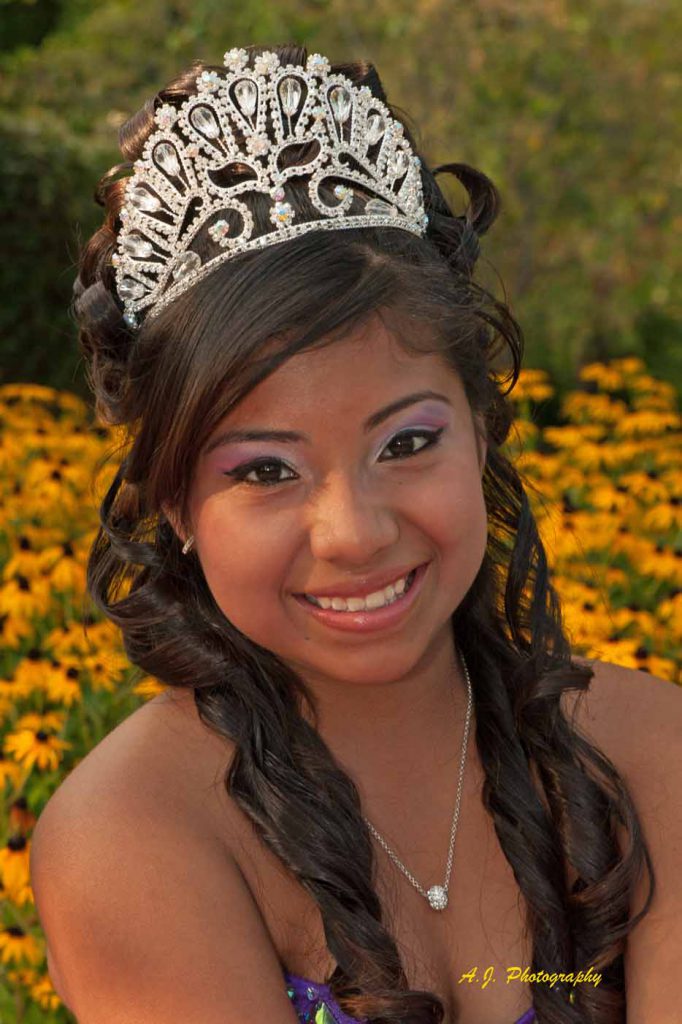 Quinceañera girl among the flowers